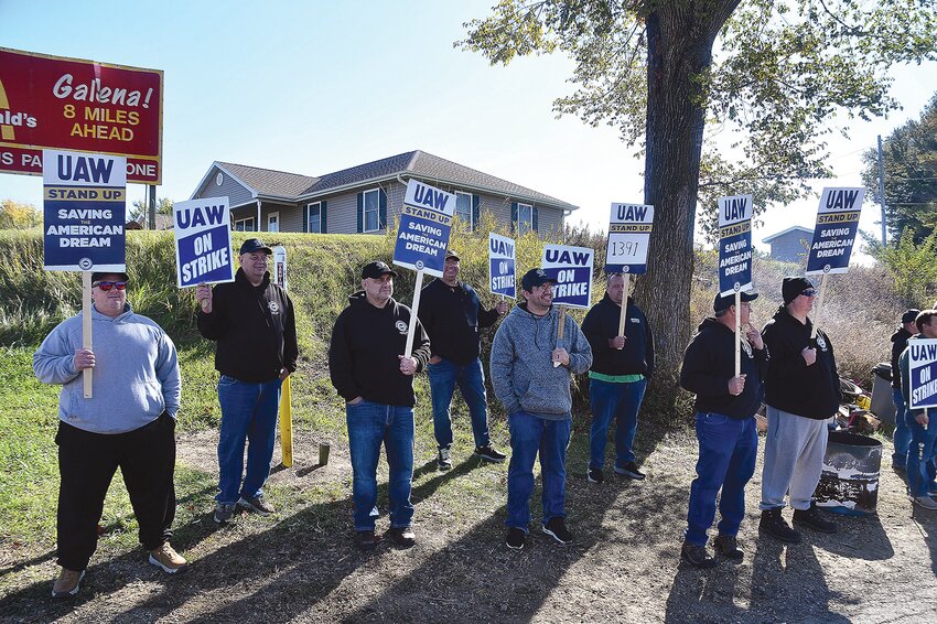 United Auto Workers, Local 1391 at the intersection of U.S. 20 and Chemical Plant Road demonstrate they are on strike as people drive by.