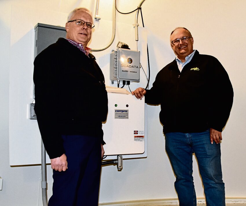 From left, East Dubuque city manager, Bob Sietz, and project manager, Marc Ruden, stand next to the control panel inside the tower.