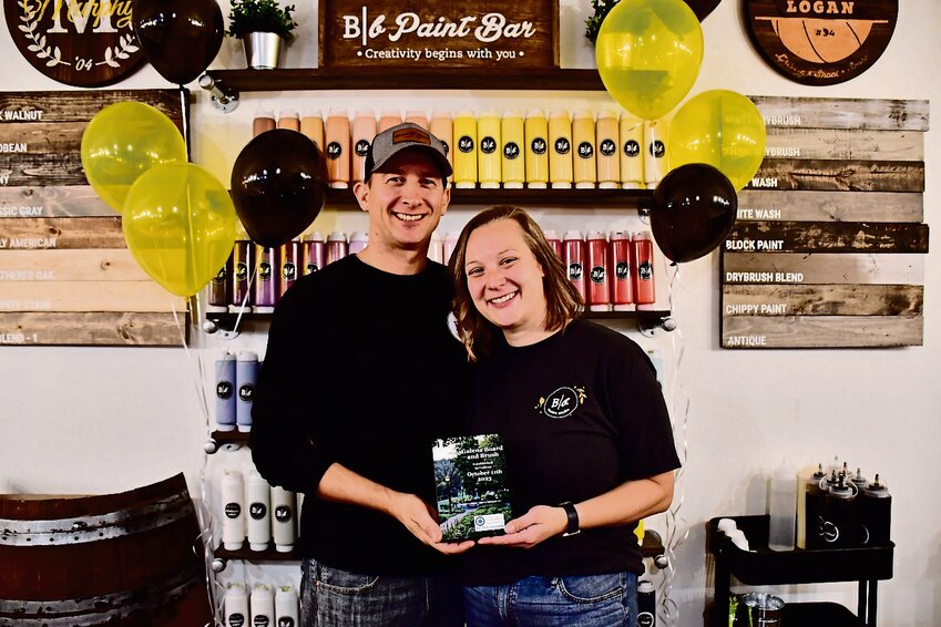 Curran and Jen Lane received a plaque from the Galena Area Chamber of Commerce during Board and Brush's grand opening. Those in attendance had a chance to eat food and grab a goody bag.