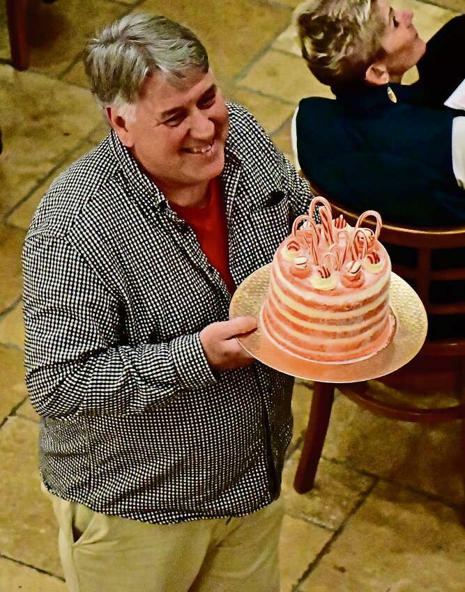 Executive Director of the Galena ARC Dave Decker carries around cakes donated by members of the community during the annual cake auction, a fundraiser for the ARC.