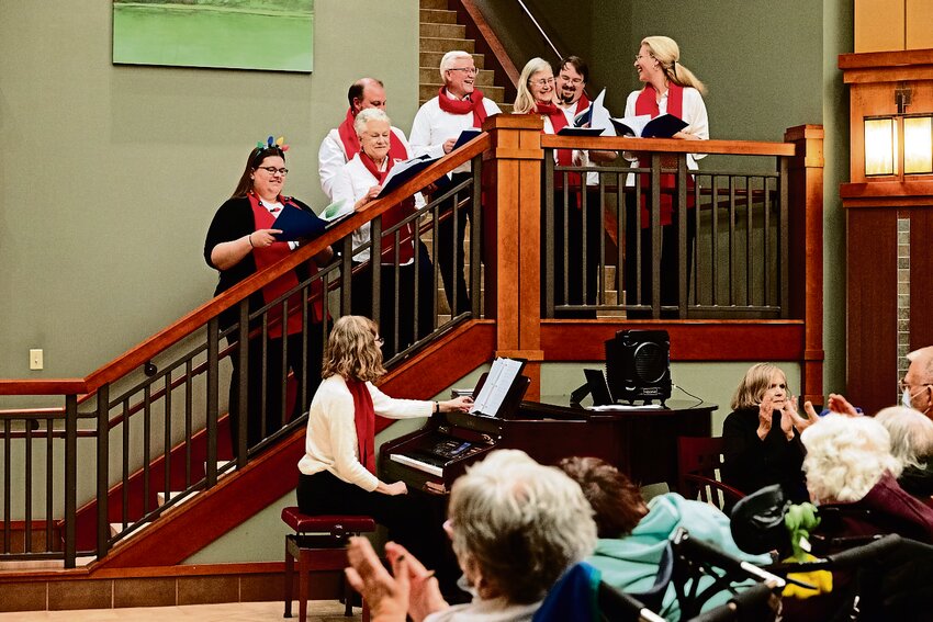 In matching red scarves and white tops, the Love Notes share smiles and laughs in their performance for the hospital&rsquo;s tree lighting ceremony.