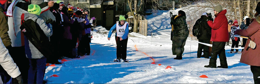 February: Spectators cheer on  Colleen Costello while she races in the 1600-meter snowshoe race.