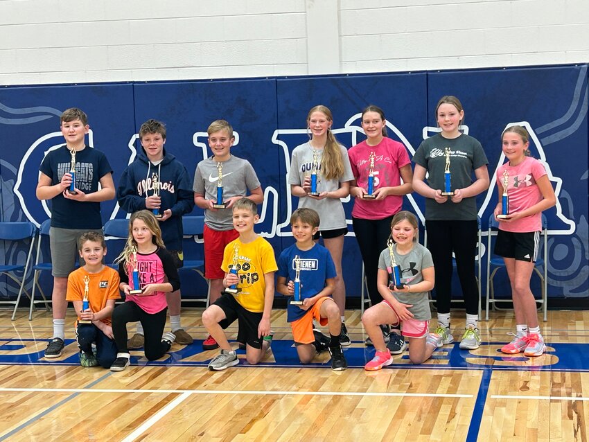 The first and second place winners of the Hoop Shoot Competition display their trophies. Front from left, Luke Meusel, Sidney Meusel, Walker Knight, Gavin Berning and Kirra Temperly; back row, Brock Turner, Matthew Duerr, Emmett Patterson, Ally Heitkamp, Madison Wurm, Lilly Jordan and Kaitlyn Watson.