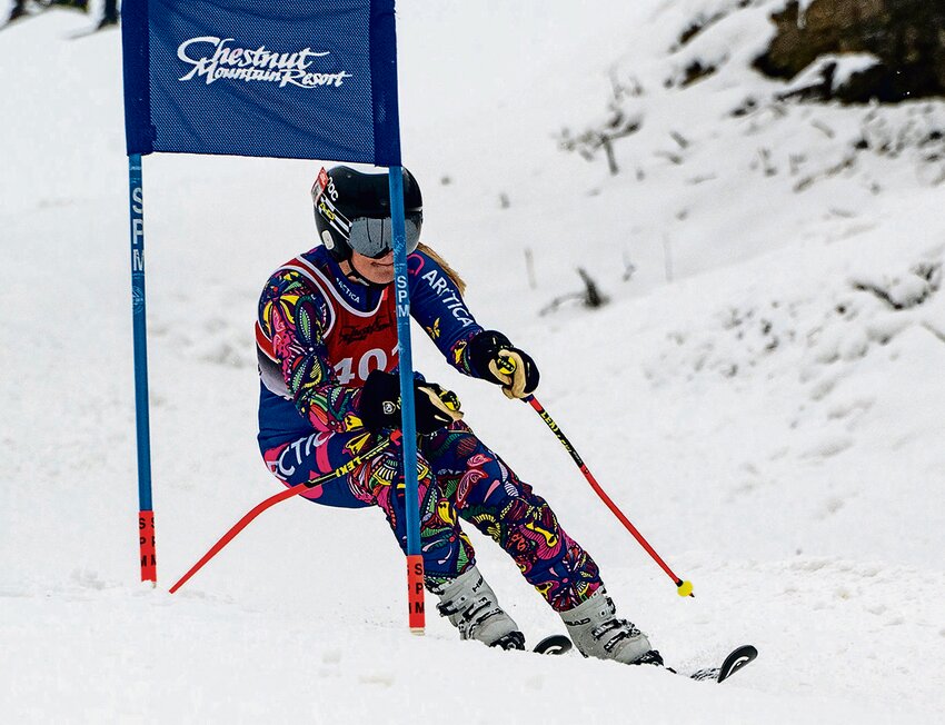Abigail Kruger passes a Giant Slalom gate on the Apache race course earning a first place for Chestnut in race two of the Giant Slalom competition with a time of 37.860 seconds, 0.040 seconds ahead of the second place finisher, Estella McMurry of the Blackhawk Ski Team.