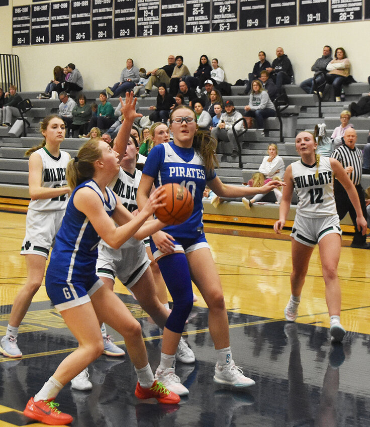 Addie Hefel prepares to shoot the ball while Navaeh Hauber blocks out an unidentified RRSM defender. Gwen Miller (22) and Laiken Haas (12) are ready for a rebound.