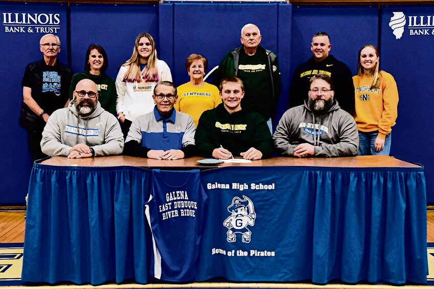 Galena senior Cooper Einsweiler committed to throw shot put as well as discus, his personal favorite, at St. Norbert College in De Pere, Wis. The biomedical sciences major will potentially add hammer, weight throw and javelin to his regular events as a Green Knight. Front, from left: Coaches David Eaton and Dan Gunning, Cooper Einsweiler, Coach Brett Frye. Family members, back from left: Robert Farrington, April Einsweiler, Cameron Einsweiler, Vicki Einsweiler, Mike Einsweiler, Michael Einsweiler and Sydney Einsweiler.