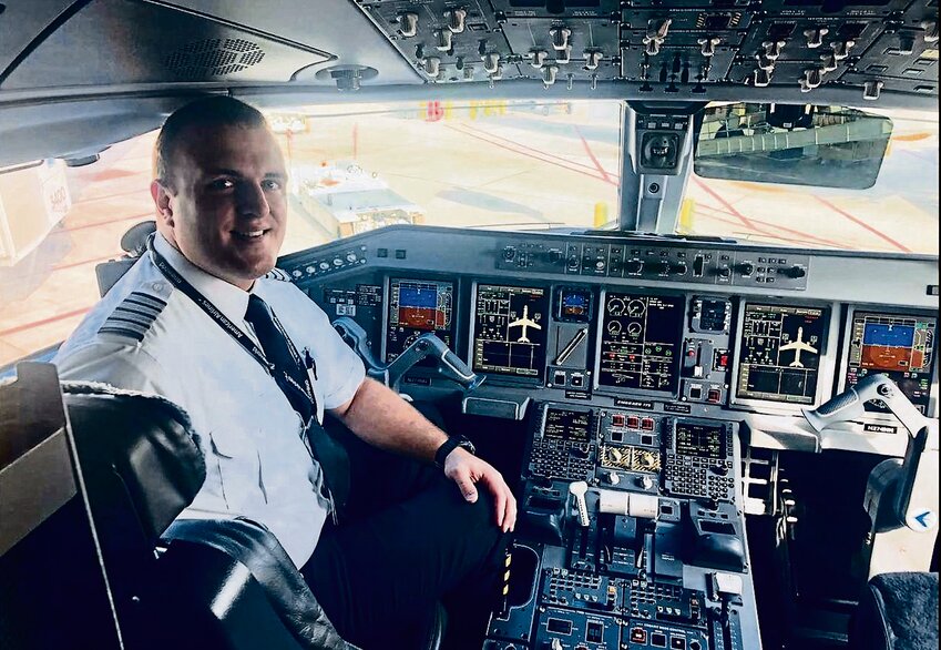 Waiting for passengers to board, Jesse Sinagra captains an Envoy Airline aircraft in August 2022.