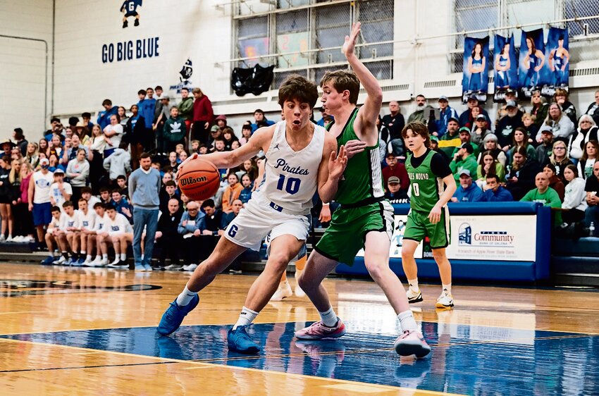 Galena&rsquo;s Drew Koenigs drives into Scales Mound&rsquo;s Max Wienen in the squads&rsquo; meeting on Feb. 1. Koenigs finished the conference duel with a double-double, hauling in 15 rebounds and 10 points.