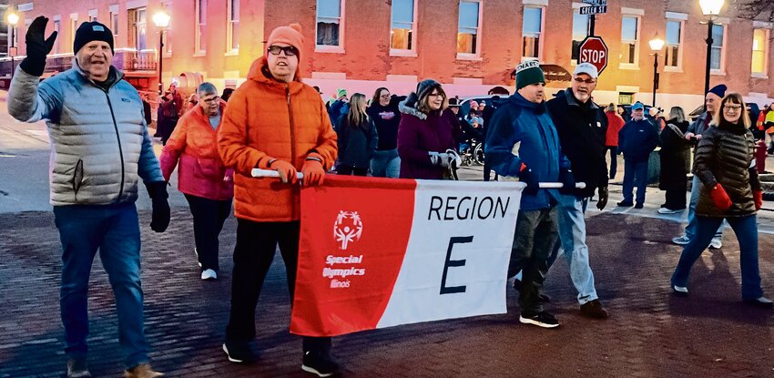 Illinois Special Olympics Winter Games Parade was led by Region E. Jim Sproule waves to the spectators as they enter the Grand Opening Ceremony area.