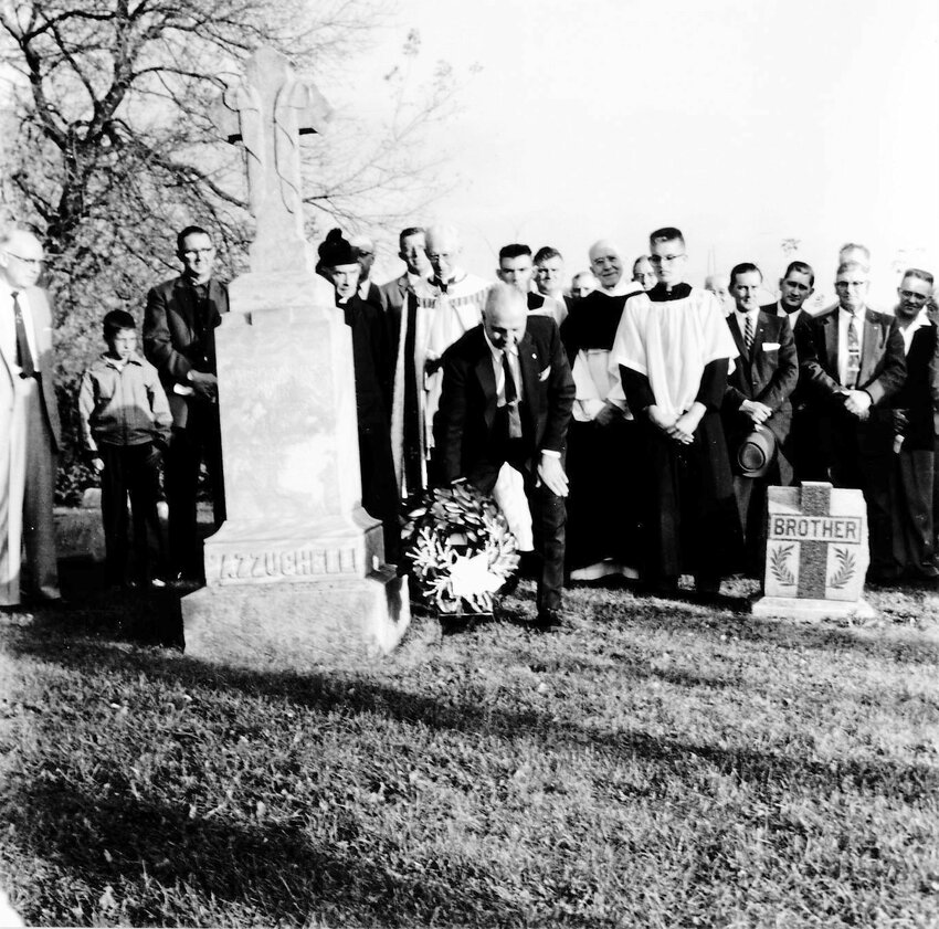 This is a picture of a ceremony of laying a wreath at his grave