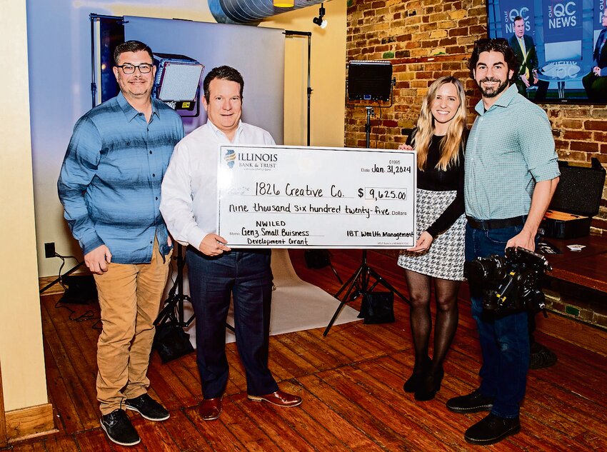 The owners of 1826 Creative Company were presented with a check recently from the Genz Small Business Development Fund to purchase new equipment for their business. From left are: David Schmit with NWILED, Gavin Doyle from Illinois Bank and Trust, a division of HTLF Bank, Michelle and Brendan Sullivan with 1826 Creative Company.