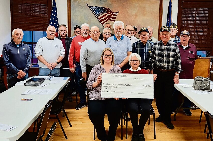 Tessa Flak, front left, Historical Society Executive Director, is presented a check from the members of the Galena VFW Post 2665 at their March 12 meeting.