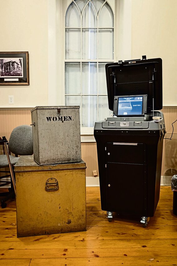 Antiquated ballot boxes contrast with modern day voting machines inside East Galena Town Hall.