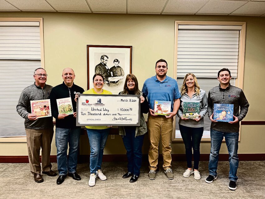 Officials from First Community Bank of Galena and Apple River State Bank recently presented a $10,000 sponsorship to the United Way for the Dolly Parton Imagination Library Program. Pictured from left are: Joel Holland, Greg Duerr, Marcy Doyle, United Way of Northwest Illinois Executive Director Connie Kraft, Devin Patterson, Ashley Peterson and Zeke Winders.