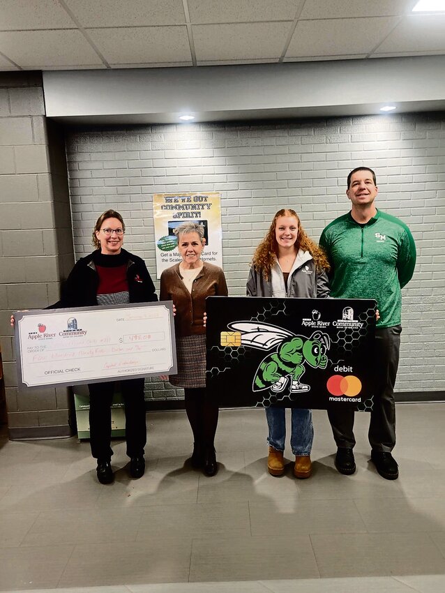 Accepting the donation from Apple River State Bank for the Scales Mound Schools, from left: Crystal Erdenberger, Superintendent Dr. Marybeth Whitney-DeLaMar, Anna Wentz, Principal Dr. Matt Wiederholt