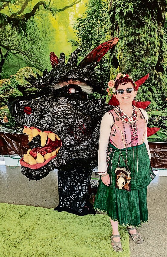 Organizer of the first Spring Festival, K Kriesel, shows off the festival&rsquo;s own dragon, Karza, an 8-foot dragon head animatronic puppet utilizing over 2,000 LEDs.