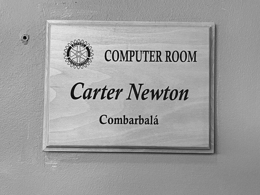 A plaque hangs in honor of Newton outside Escuela America&rsquo;s English language computer lab.