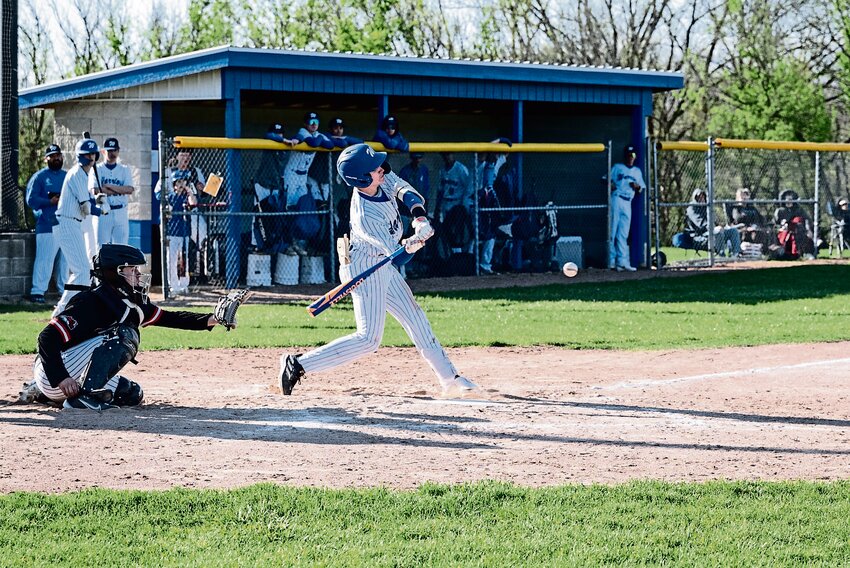 East Dubuque&rsquo;s Carver Kamentz drills a line drive in an earlier season match-up against the Fulton Steamers. Kamentz tallied three RBIs, two doubles and a triple in the Warrior&rsquo;s win over Southwestern on April 29.