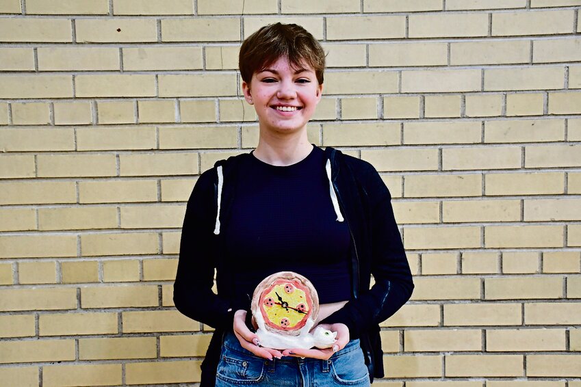 Sophomore Kennedy Roddick is the artist of the month for early May. Above, she displays a cat clock she created. Roddick said that &ldquo;art is subjective,&rdquo; so the same piece can mean different things to different people. She added that it also connects people and expresses what words can&rsquo;t. Roddick and her father connect through art because her dad shows her his high school art pieces. &ldquo;I like to make art that is personal to me and has a story behind it. Most of my art has a story about me in it,&rdquo; she said.