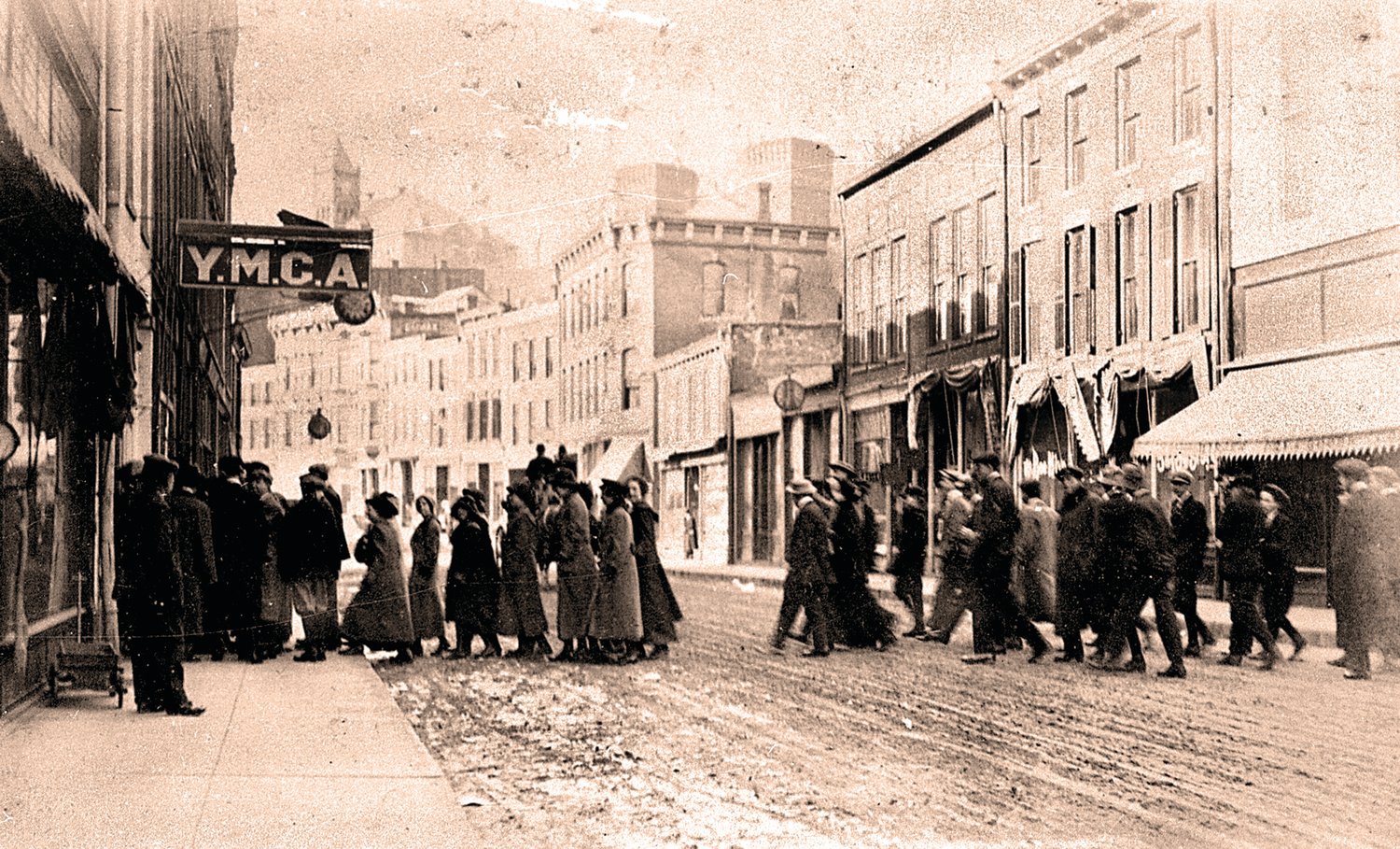 A crowd walks into the YMCA building, 114 S. Main St., Galena, on Armistice Day, Nov. 11, 1918. A few days later the building was converted into a hospital to care for flu patients.