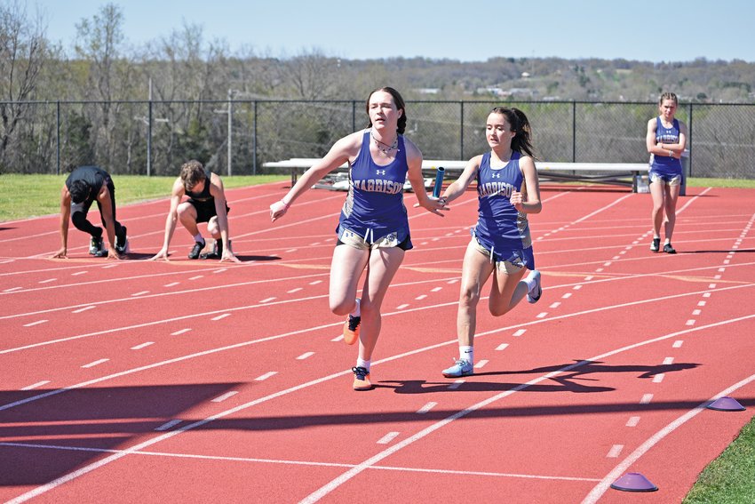 Harrison&rsquo;s Abigail Matlock (left) receives the baton from teammate Searra Shairrick during a relay at Jo. T. Cash Track in Thursday&rsquo;s Senior Goblin Rosson Invitational. The Lady Goblins finished third in the 13-team meet.
