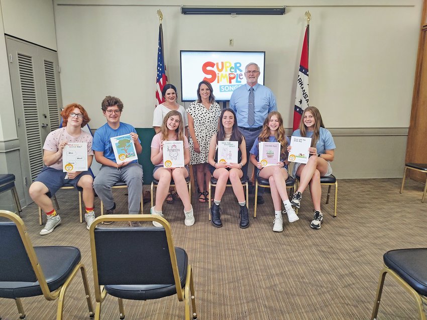 Harrison Middle School students (front) Ocean Mullins, Mark Green, Sydney King, Ella Domino, Jacklyn Tapley and Eliza Barger and faculty (back) Mrs. Goulet, Mrs. Benson and Principal Fred Wilson came to the library with the gift of new books that were created by the students.