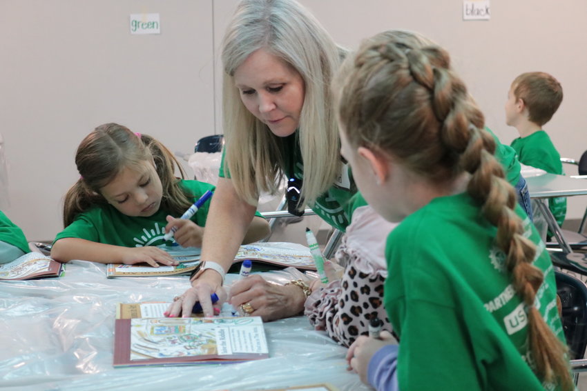 Instructor Melissa McDonald assists campers with STEM projects.