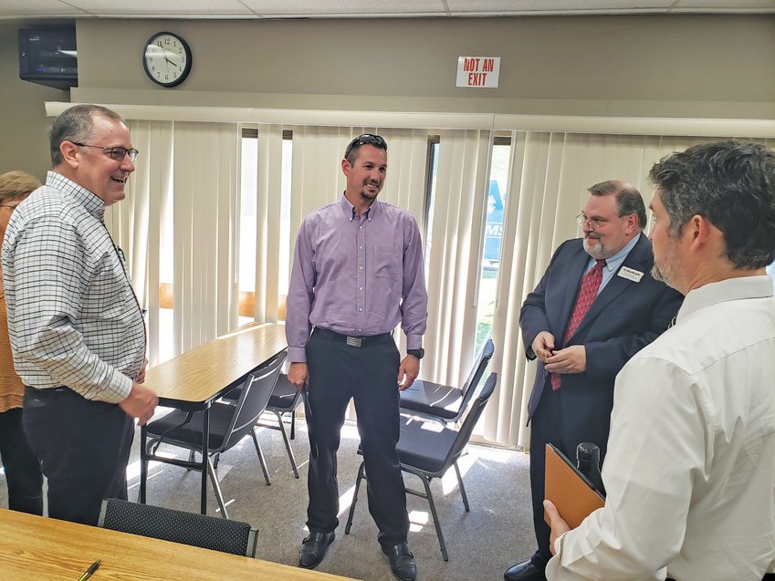 Harrison city chief financial officer Luke Feighert (center) talks with (from left) North Arkansas College Board of Trustees member Scott Miller, college vice president of finance and administration Richard Stipe and vice president of academic affairs Matt Cardin after a board recent meeting. Feighert is running unopposed for the college board in the November General Election.
