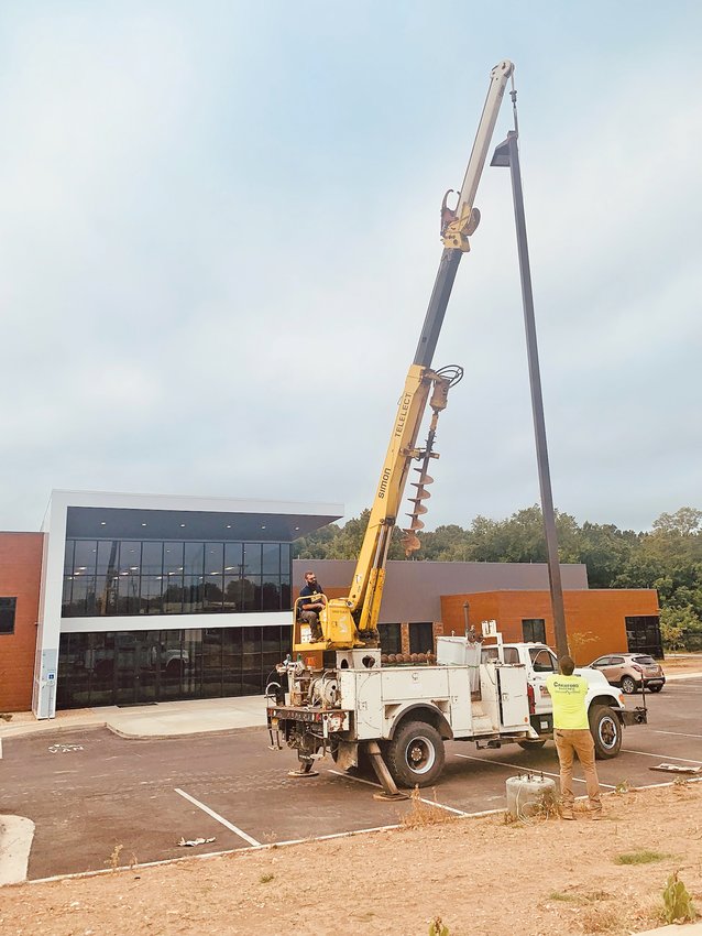 Workers for Crawford Electric install night lights Monday morning for the front of the new Harrison City Hall and Public Safety facility on Industrial Park Road.