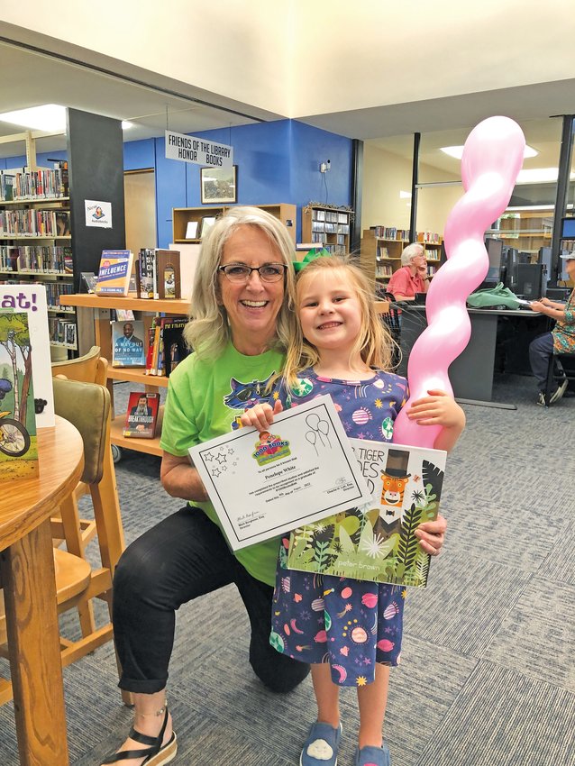 Penelope White (right) completed the 1,000 Books Before Kindergarten program at the Boone County Library. Ginger Schoenenberger presented her award for her hard work.