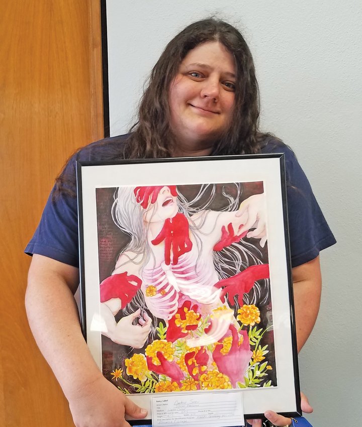 Candace Snow displays her winning work of art titled &ldquo;Lost Innocence&rdquo; that won 1st place in the SWOP art show.