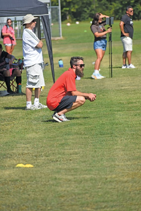 North Arkansas College soccer coach Sam Hughes kneels to the ground to get a look at his players. The Pioneers will be hosting their first regular season home game on Friday. Kick off is at 5:30 at the Harrison Soccer Complex.