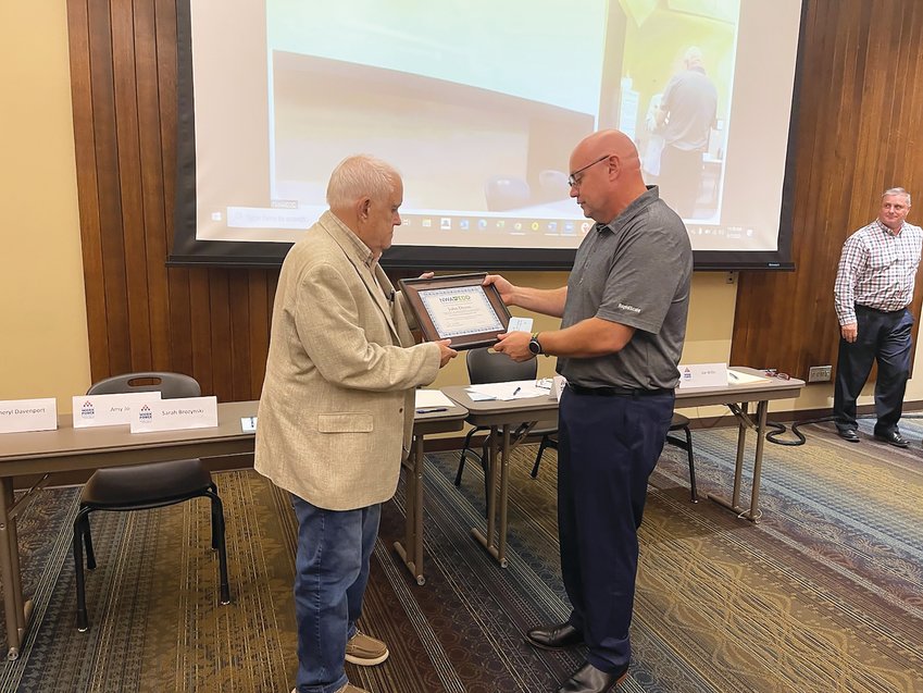 9.17 Dyess Bo  Donna Braymer/Staff&nbsp;  The recently elected chairman, Bo Phillips of Cox Communications presented a plaque to John Dyess who served the Northwest Arkansas Workforce Development Board of Directors for 36 years and served as chairman for 20 years.