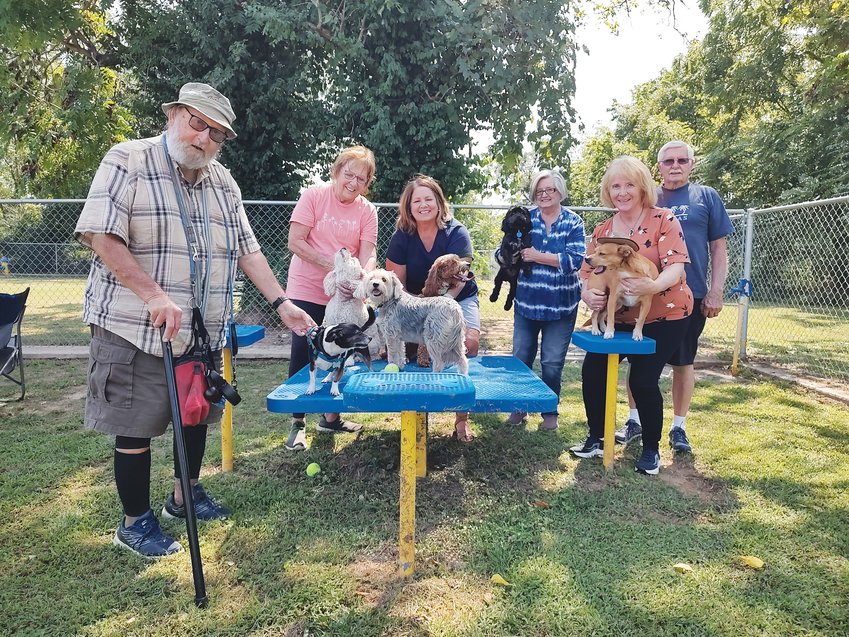 The Bark Park Buddies (from left) John Prichard with Little Guy, Mary Jehnke with Olivia, Debbie Martin with Maddie, Cindy Dillinger with Stevie and Pebbles and Warren and Diane Mickelson with Cody enjoy a sunny afternoon at the Kiwanis Dog Park.