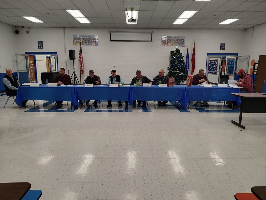 TERRI IVIE SMITH/Staff   The Ozark Mountain School Board (from left) Superintendent Jeff Lewis, Travis Dixon, Gary Lovell, Randy Brumley, Donald Morris, Ben Taylor, Jesse Rose and Travis Freeman discuss what&rsquo;s next for the District.