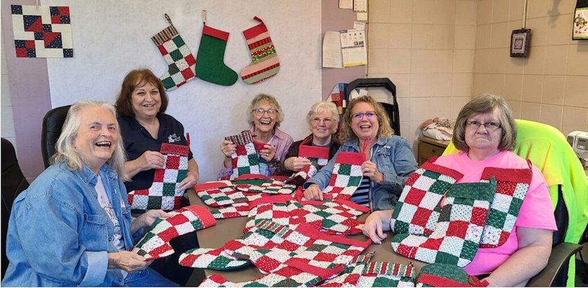 Contributed photo   Janice Sloan (from left), Cindy Creager, Rose Szabrowicz, Nancy Keeling, Mary Quincey and Glenda Ogden, the Newton County Sewphiscticated Scrappy Quilter Elves, made Christmas stockings for Three Wishes for Ruby&rsquo;s Residents.