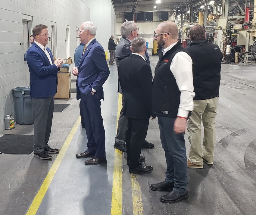 James L. White/Staff   Pace Industries president Jason Allen (left) talks with Gov. Asa Hutchinson during a tour of the Harrison plant Monday afternoon.