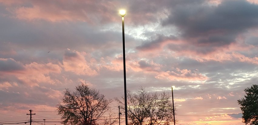 Lights outside Harrison City Hall on Industrial Park Road shine against a brilliant fall sunrise. JAMES L. WHITE/STAFF