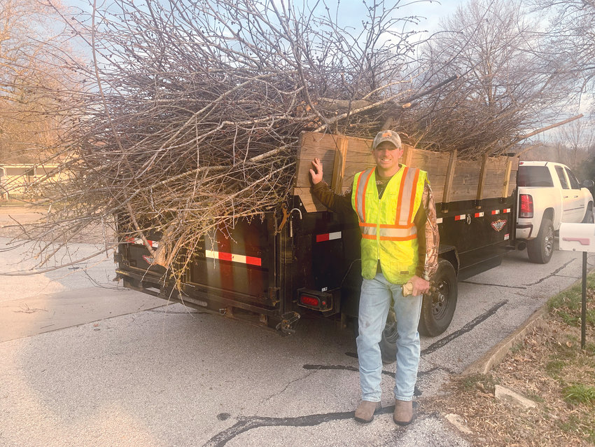 The city of Harrison is providing a one-time curbside tree and limb pickup event for properties inside the city limits. The city is contracting with local companies 726 Tree Service, All Terrain Tree Service, and Villines Tree Service to complete the pick-up program. Pictured is Clint Villines with Villines Tree Service standing by a truck full of limbs his company picked up on Tuesday morning along South Clifford Street. CONTRIBUTED PHOTO/LEE H. DUNLAP