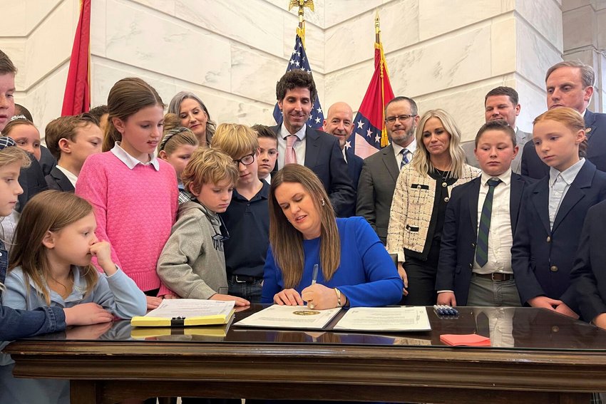 Arkansas Gov. Sarah Huckabee Sanders signs into law an education overhaul bill on Wednesday, March 8, at the state Capitol in Little Rock. (AP Photo/Andrew DeMillo)