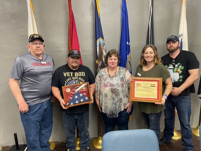 Susan Pruitt (center) recently presented a Battle Flag flown over Camp Fernandez-Long-Plank, an American base near Fallujah, Iraq, to Camp Jack.The flag was given to her by a relative who served there in 2004.  Receiving the flag on behalf of Camp Jack are Iraq veterans David Jones, Joe Jones, Callie Mondy and Aaron Bass.