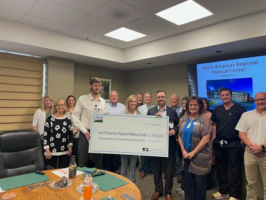 Dan Dillard presented a large check in front of the NARMC Board of Directors to symbolize the $145,000 funding the hospital received from a joint effort with the NWAEDD. The funds were used to pay for the new phone system the hospital needed. DONNA BRAYMER/STAFF