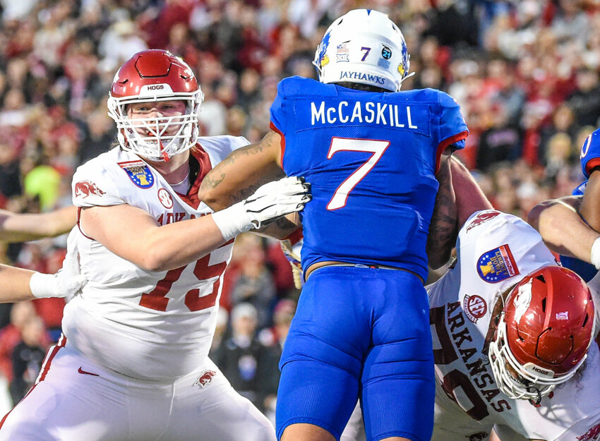 CRAVEN WHITLOW/NATE ALLEN SPORTS SERVICES   Razorback sophomore offensive lineman Patrick Kutas (left) from Memphis, Tenn. pass&nbsp;blocks during&nbsp;the 2022 Liberty Bowl against Kansas. Kutas is looking to make a start for Arkansas in the first game of the season.