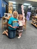 Oklynn Baughman (left) proudly celebrates the completion of the 1,000 Books Before Kindergarten program at the Boone County Library with Ginger Schoenenberger, Library Director. CONTRIBUTED PHOTO