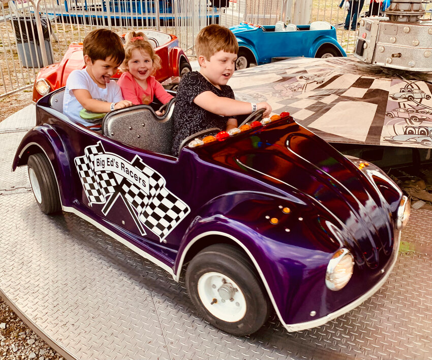 These youngsters enjoy one of the rides for kids at the Carnival on Wednesday night, Sept. 20, at the Northwest Arkansas District Fair held at the fairgrounds in Harrison. The Carnival will be open at p.m. Friday night and at 1 p.m. Saturday.