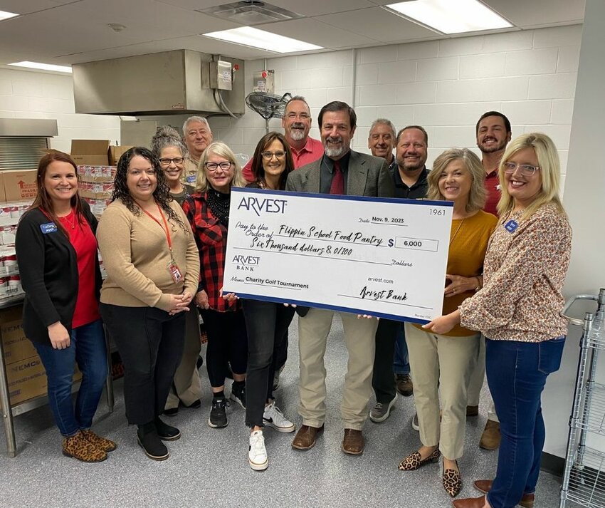 Flippin School Food Pantry is presented a check for $6,000.00, donated by Arvest Bank. Arvest hosts an annual Charity Golf Tournament. A total of three local charities each received $6,000 from this year's tournament. CONTRIBUtED PHOTO