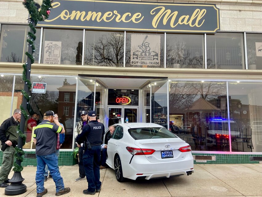 A Toyota Camry impacted the front entryway of the Commerce Mall, formerly Fraley's Furniture, in downtown Harrison on Friday. LORETTA KNIEFF / STAFF PHOTO