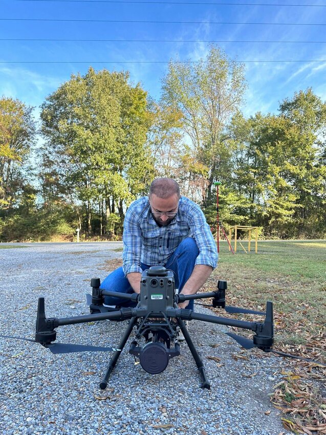 Hamdi Zurqani, remote sensing researcher and assistant professor for the College of Forestry, Agriculture and Natural Resources at University of Arkansas at Monticello, inspects a drone outfitted with a LiDAR, or light detection and ranging, system. CONTRIBUTED PHOTO