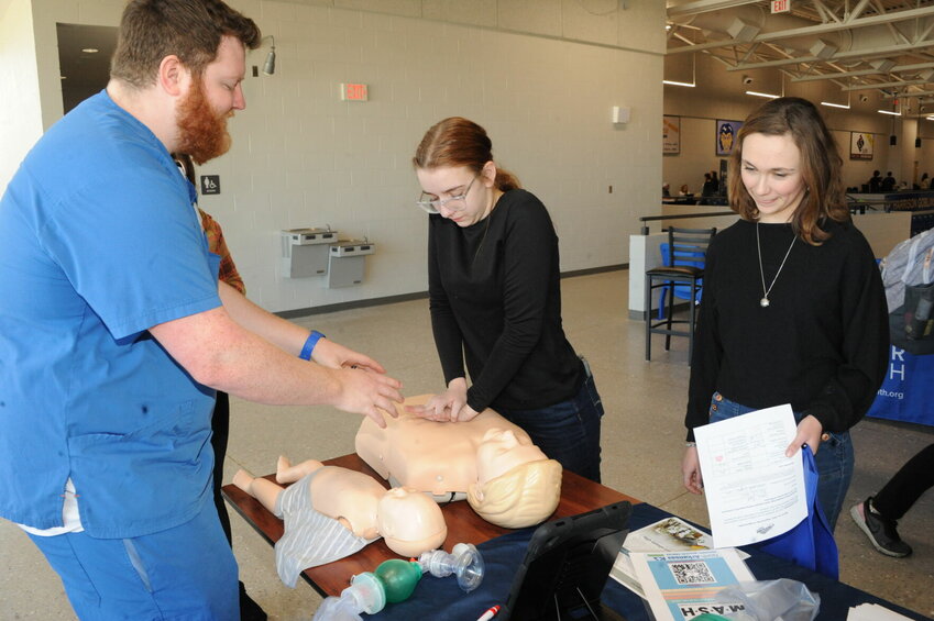 NARMC Registered Nurse Shelton Rose demonstrates CPR techniques to Emma Bock and Mattea Emerson. CONTRIBUTED PHOTO / LEE H. DUNLAP