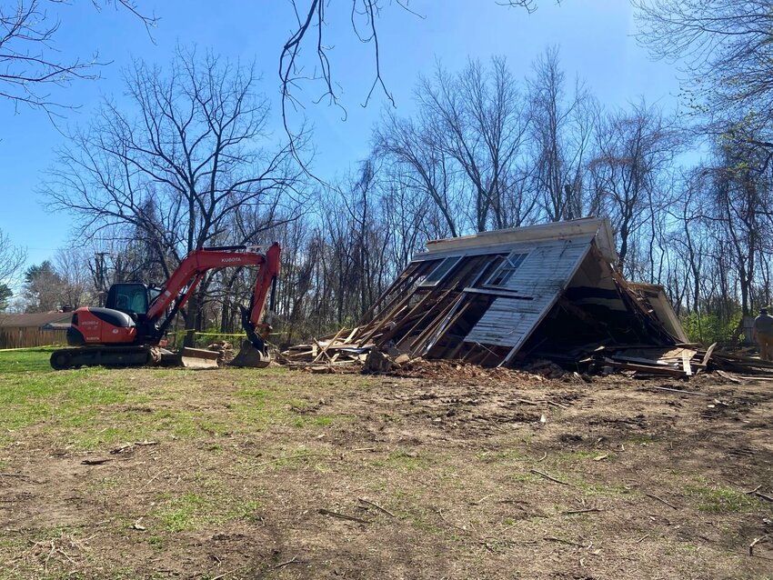 Roy Shatwell (left) and his father, Dean, of DSR Excavations stand at the site of the home on Speer Drive that they have worked to dismantle this week. Many pieces of the structure are being reused by members of the community rather than being wasted. LORETTA KNIEFF / STAFF